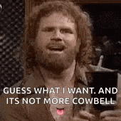 a man with a beard is holding a glass of beer and a cigarette .