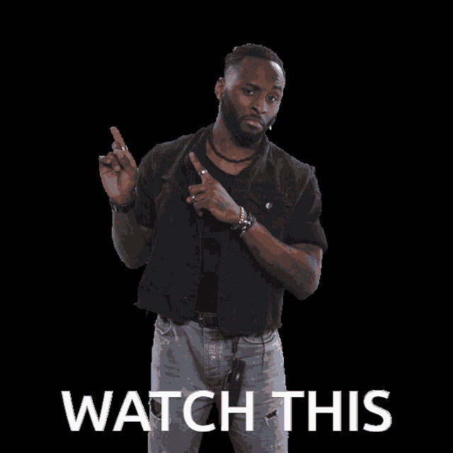 a man stands in front of a black background and says watch this