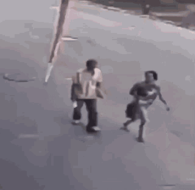 a person is standing on the side of a road with a tire hanging from their head .