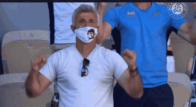 a man wearing a face mask and a shirt that says roland garros