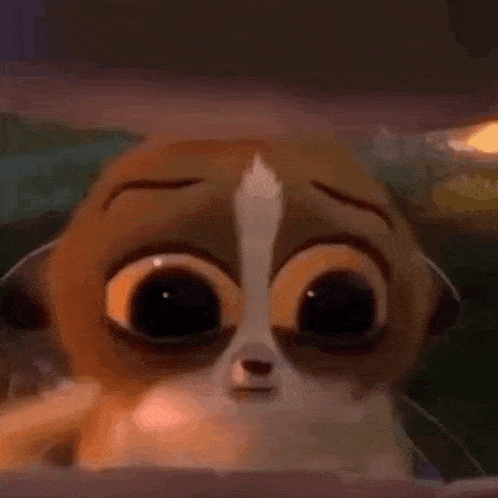 a close up of a cartoon cat with big eyes and a sad look on its face .