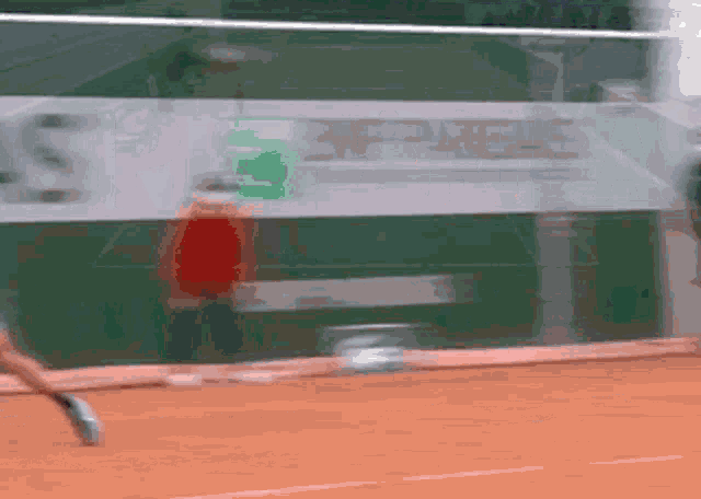 a blurred image of a tennis player with a sign in the background that says ' lacoste '