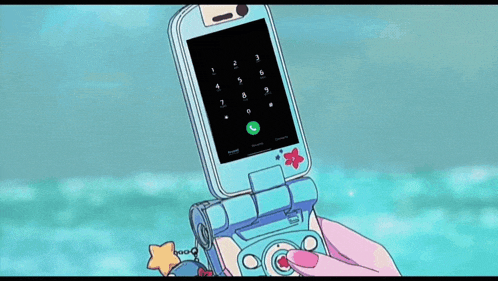 a person holding a flip phone with the number 9 on it