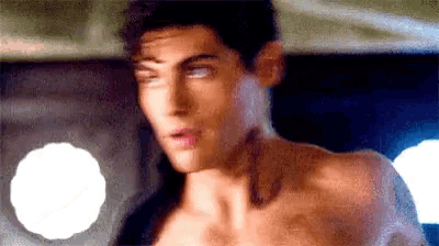 a close up of a shirtless man 's face and neck .