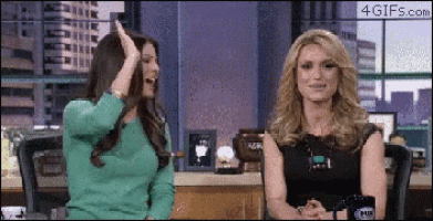 two women are sitting next to each other and one has a fox logo on her shirt