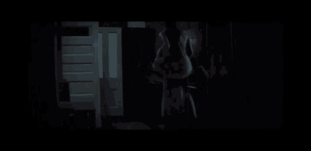 a dark room with a light on the wall