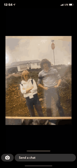 a picture of a man and a woman standing next to each other with a stop sign in the background