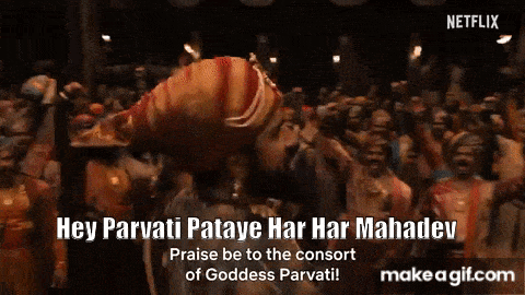 a man is standing in front of a crowd with his hands in the air and says hey parvati pataye har har mahadev