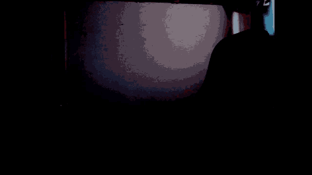 a dark room with a blue light shining through the window