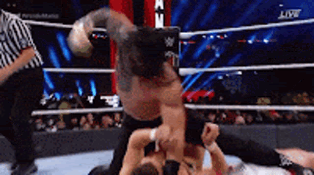 a man is wrestling another man in a wrestling ring