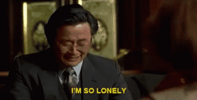 a man in a suit and tie is crying while sitting in a chair .