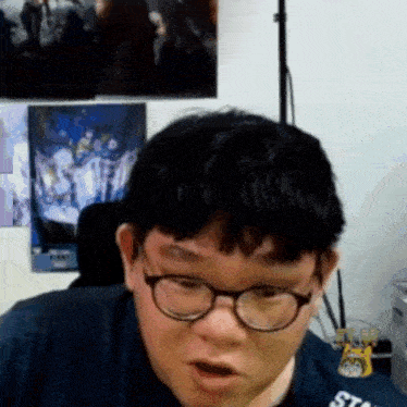a man wearing glasses and a t-shirt that says star on it