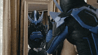 a person in a superhero costume is standing in front of a mirror .