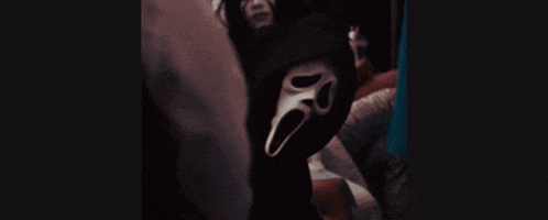 a person wearing a mask with a screaming face on it