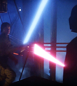 a man is holding a red light saber while another man holds a blue light saber