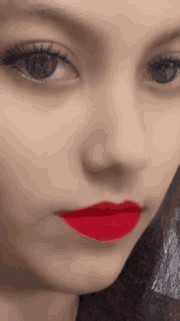 a closeup of a woman 's face with red lipstick