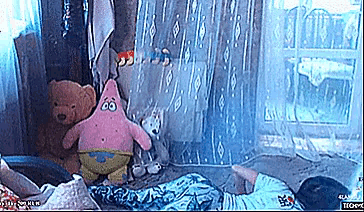 a person laying on the floor with stuffed animals and a patrick star stuffed animal