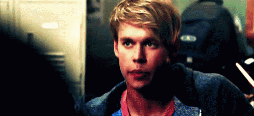 a close up of a young man 's face in a dark room .