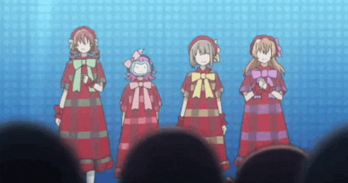 a group of anime girls are standing next to each other in front of a crowd .