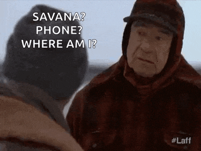 a man in a hat is talking to another man in a snowy field .