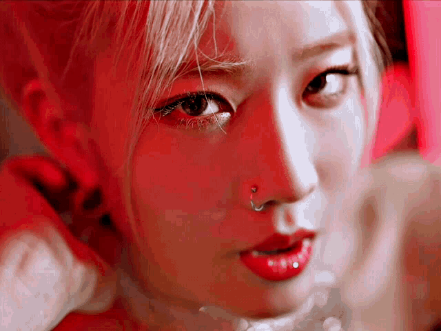 a woman with a nose ring and red lips