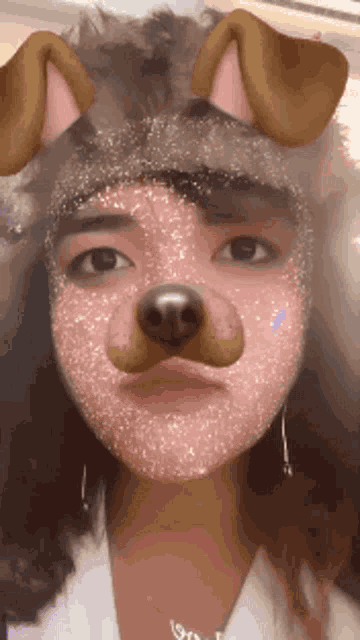 a woman is wearing a dog mask on her face .