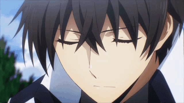 a close up of a boy with his eyes closed