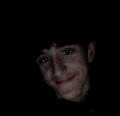 a close up of a man 's face in the dark .