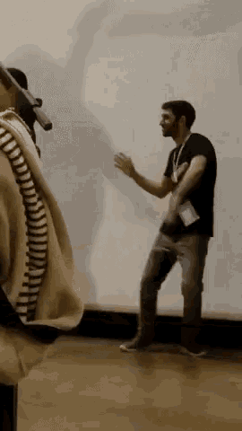 a man with a lanyard around his neck is dancing