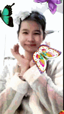 a girl with a flower in her hair and butterflies flying around her