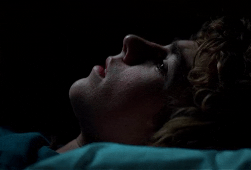 a close up of a person laying down with their eyes closed