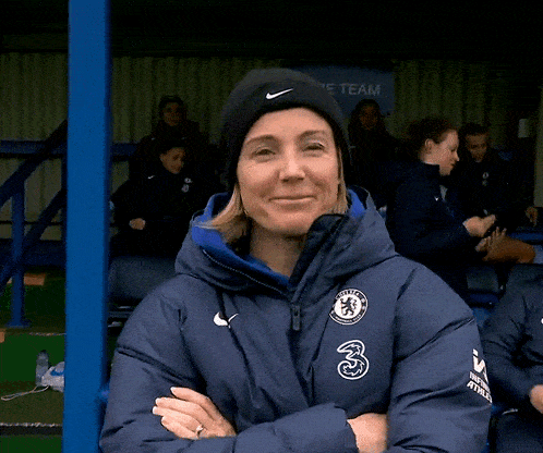 a woman wearing a black nike hat and a blue jacket with the chelsea logo