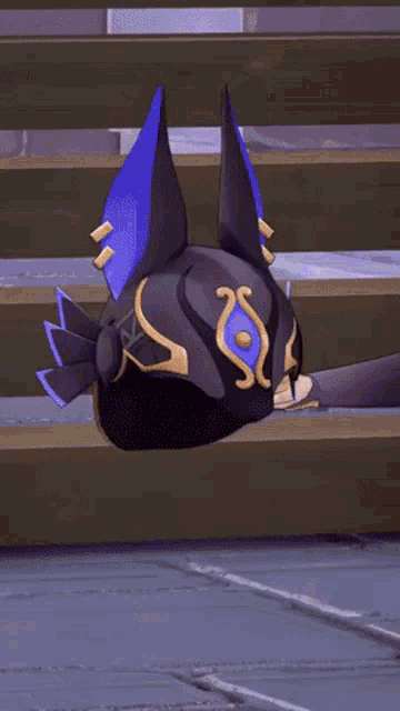a cartoon character is laying on the ground with a purple and gold helmet on .