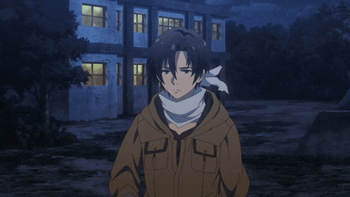 a man with a scarf around his neck stands in front of an old building
