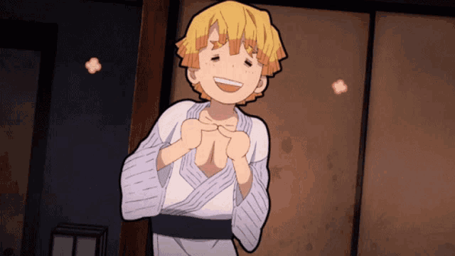 a yellow haired anime character is smiling and making a heart shape with his hands