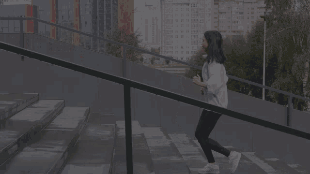 a woman is running up a set of stairs with the name colefna on the bottom