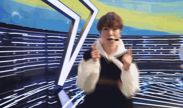 a blurry picture of a person giving the thumbs up
