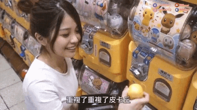 a woman in a white shirt is playing a game with chinese characters