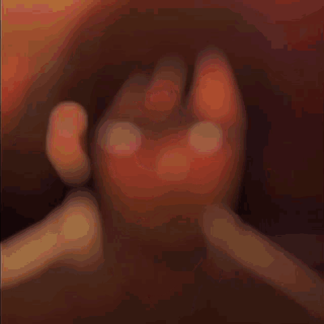 a blurred image of a person 's face with a yellow and red background