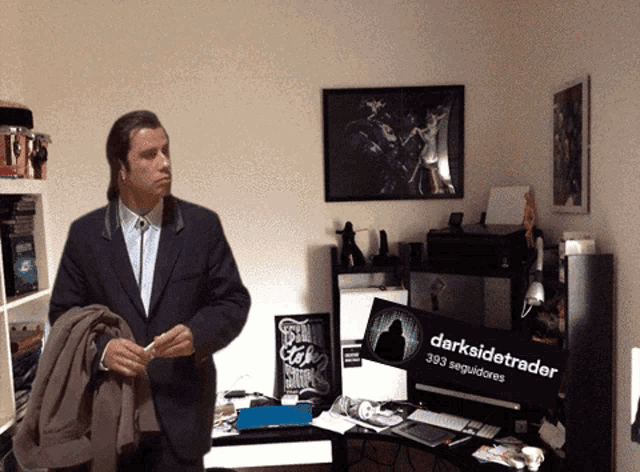 a man in a suit stands in a room with a sign that says darksidetrader