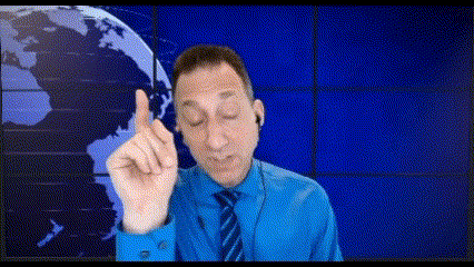 a man wearing a blue shirt and tie is pointing up