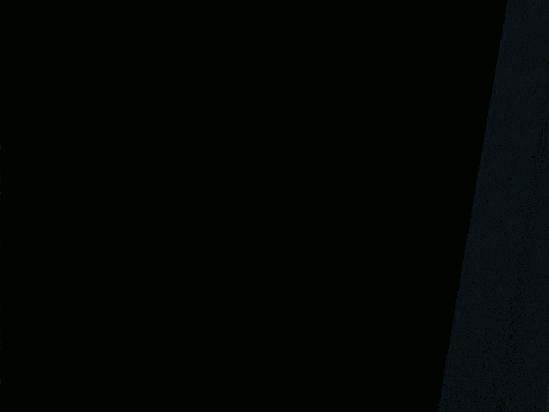 a dark room with a light on and the letter l on the wall