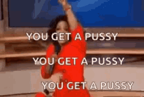 a woman in a red dress is singing into a microphone while holding a microphone .
