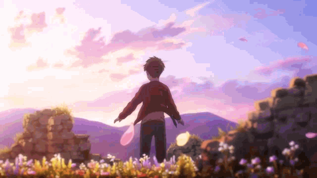 a man is standing in a field of flowers with his arms outstretched at sunset