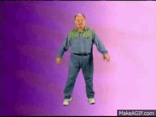 a man is dancing in front of a purple background with makeagif.com written on the bottom