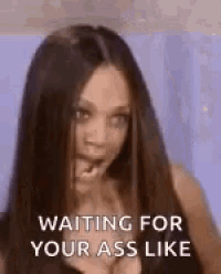 a woman with long hair is making a funny face and saying `` waiting for your ass like '' .