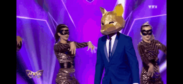 a man in a suit and tie with a mask on his head