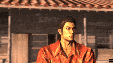 a man in a red shirt stands in front of a building with chinese writing