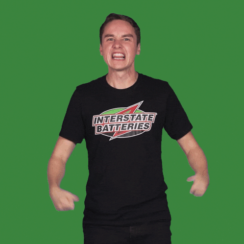 a man wearing a black t-shirt that says interstate batteries on it