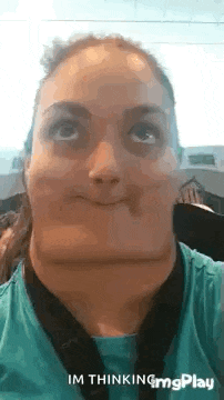 a woman is making a funny face with her mouth wide open and looking up .